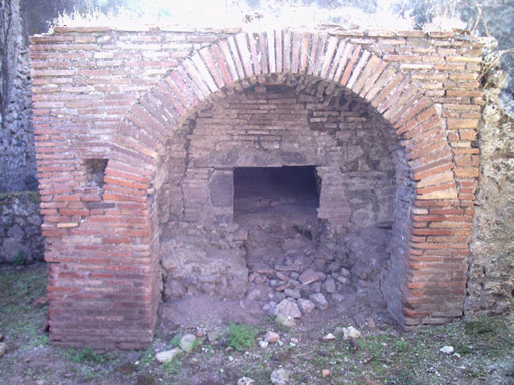 VII.12.11 Pompeii. July 2008. Looking south to front of oven, with small recess and pipe, on left. Photo courtesy of Jared Benton.
