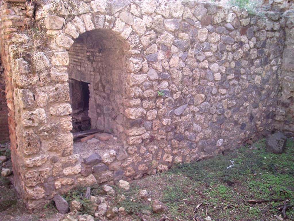 VII.12.11 Pompeii. July 2008. Wall at side of oven, in room on its west side. Photo courtesy of Jared Benton.