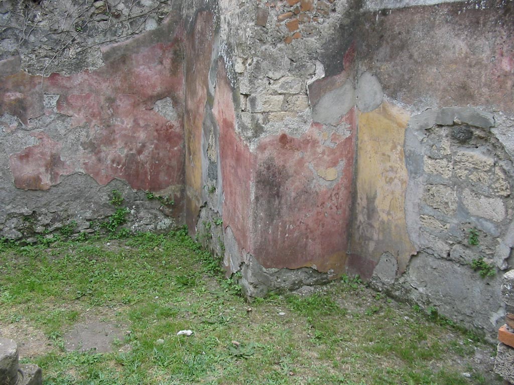 VII.12.15 Pompeii. May 2003. South-west corner of triclinium/rear room. 
The remaining painted walls would appear to show alternating red and yellow panels. Photo courtesy of Nicolas Monteix