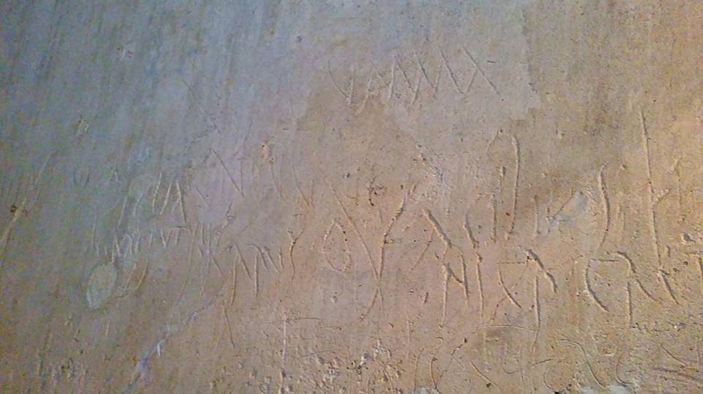 VII.12.18 Pompeii. 2015/2016. 
Plastered wall of prostitute’s room covered with graffiti left by the clients and the girls that worked there. Photo courtesy of Giuseppe Ciaramella.