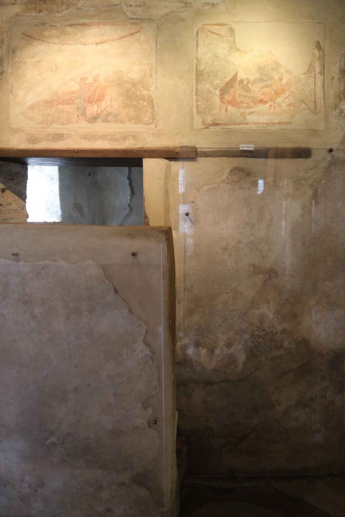 VII.12.18, Pompeii. December 2018. Doorway to the latrine at the west end, behind the screen. 
Photo courtesy of Aude Durand.