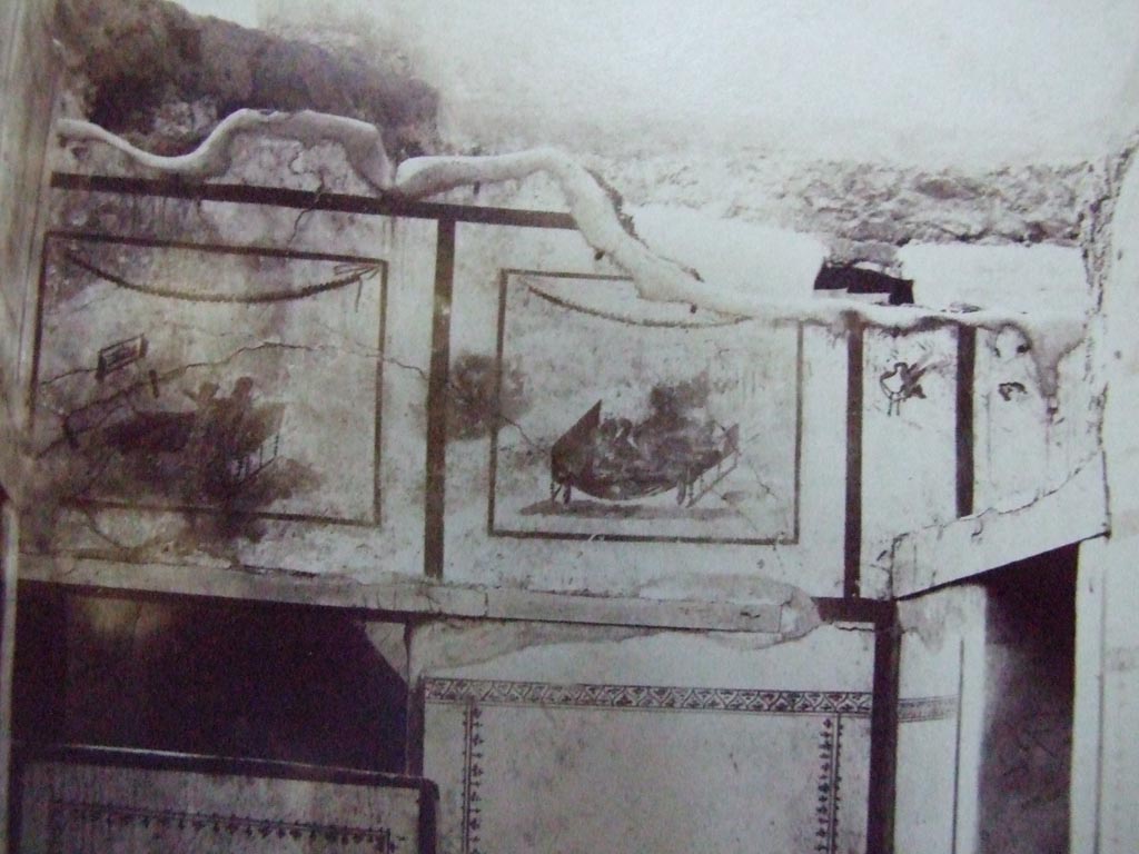 VII.12.18 Pompeii. Old undated photo showing same frieze on upper wall at west end. 
Courtesy of the Society of Antiquaries (Fox Collection).