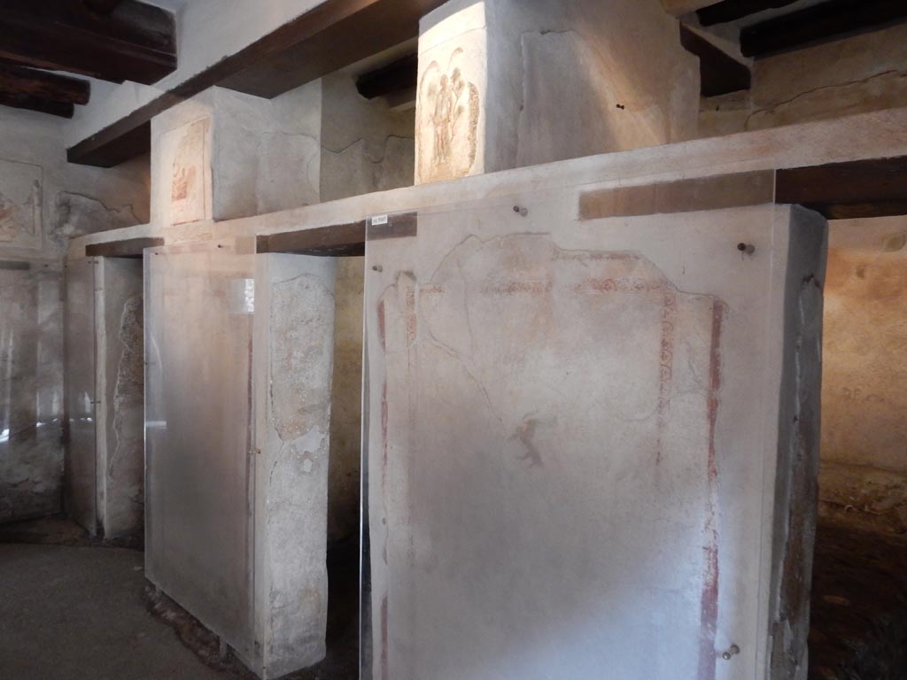 VII.12.18 Pompeii. May 2015. 
Looking towards three doorways on north side, with frieze on the upper wall. Photo courtesy of Buzz Ferebee.