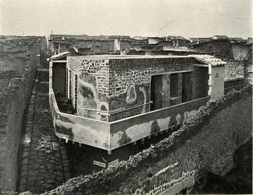 VII.12.20 Pompeii.  c.1908-1909. Looking west towards upper floor balcony/corridor around the edges of the doorways to rooms.
The doorways and window of rooms 3 and 4 can be seen, centre right, overlooking Vicolo del Lupanare.
The other doorways overlooking Vicolo del Balcone Pensile are on the left. 
According to Sogliano –
“As for the balcony, I had only its two ends reconstructed (fig. I, a, a), because the height of these was marked with certainty by the traces of ancient plaster on the outside of the walls. I did not close the remaining part of the balcony, because, although there was no longer any doubt as to its height, the number and position of the windows that were to illuminate it remained uncertain, especially as the communication doorways between the balcony itself and the chambers, due to the singular distribution given to the rooms, do not keep a regular distance between them, and are seen very close together towards the ends, leaving a large section of wall towards the middle with no openings at all. Given this configuration, various hypotheses are equally possible, but two are enough to make the restoration uncertain.  In such uncertainty, I have limited the restoration to just the two ends, which I have had covered with tiles of a similar size to the ancient ones, which seen from below appear to be the protruding part of the roof that was meant to cover the entire building.”
See Sogliano, A., 1909. Dei lavori eseguiti in Pompei dal i Luglio 1908 a tutto Giugno 1909, p. 14-15, fig 1.