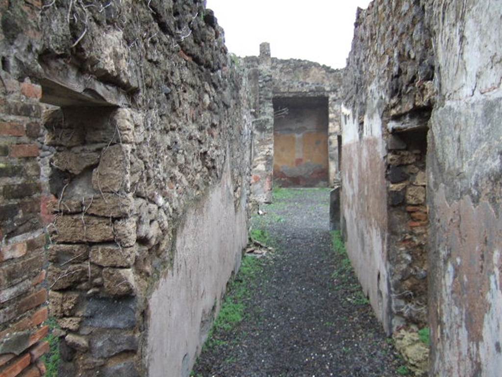 VII.12.26 Pompeii. December 2005. Fauces leading to small garden area at front of house. According to Jashemski, the garden at the front of the house was reached by a long corridor. It was enclosed on the north and east by a portico. This was supported by two columns and one engaged column which were joined by a low masonry wall. It had an entrance to the garden on both the north and east sides. According to Fiorelli, half the garden was cultivated, half of it was paved to provide a passageway to the portico. The triclinium on the north side had a fine view of the garden. A large window in the south wall of the garden gave light to the shop on the other side.
See Jashemski, W. F., 1993. The Gardens of Pompeii, Volume II: Appendices. New York: Caratzas. (p.196)