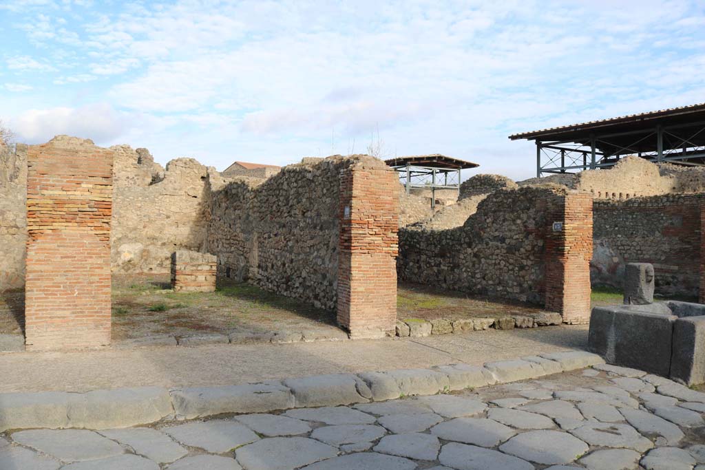 VII.14.12, Pompeii, on left. December 2018. 
Looking north-east to entrance doorways, with VII.14.13, on right. Photo courtesy of Aude Durand