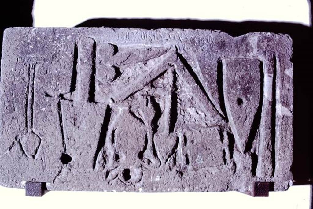 VII.15.1 Pompeii. 1972. Tufa plaque showing “Diogenes Structor” scratched in the top centre of the plaque above the tools.  
Photo by Stanley A. Jashemski. 
Source: The Wilhelmina and Stanley A. Jashemski archive in the University of Maryland Library, Special Collections (See collection page) and made available under the Creative Commons Attribution-Non Commercial License v.4. See Licence and use details.
J72f0527