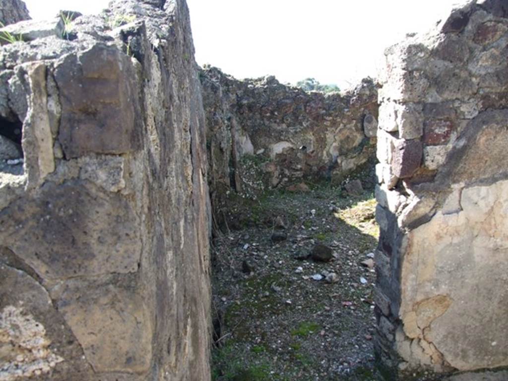 VII.15.2 Pompeii. March 2009. Tepidarium with doorway into caldarium.
The caldarium had a hypocaust system, complete with suspensurae beneath its floor. Regulae mammatae lined its south, west, and north walls. The praefurnium was stoked from the kitchen, which was on the west side.  The wall decoration of the caldarium was Second style, but no further details were recorded.  The floor was paved with cocciopesto.
See Franklin, J.L., 1990. Pompeii, the Casa del Marinaio and its history. Rome: L’Erma di Bretschneider