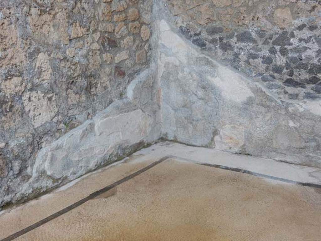 VII.15.2 Pompeii. May 2018. East ala, looking towards north-east corner. Photo courtesy of Buzz Ferebee. 
According to Sogliano, a small painting of a Cupid with the lyre in his left hand, and plectrum in his right was seen here on the wall.
(Con la lira nella sinistra, e il plettro nella destra.) (Bull.Inst 1872, p.172, Fiorelli, Scav.d.Pomp. (p.123, n.188), Descr.Pomp. (p.305).
See Sogliano, A., 1879. Le pitture murali campane scoverte negli anni 1867-79. Napoli: Giannini, (p.55, no.274)
According to PPM, towards the north-east corner, at the sides of the central paintings of the walls, two small painting of cupids were seen.
See Carratelli, G. P., 1990-2003. Pompei: Pitture e Mosaici: Vol. VII. Roma: Istituto della enciclopedia italiana, (p.725).