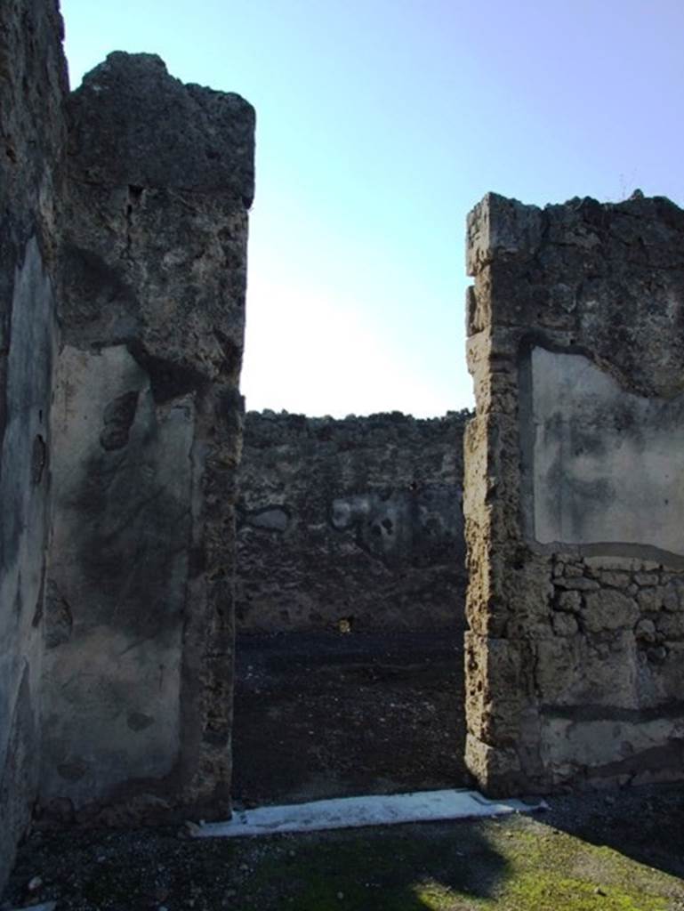 VII.15.2 Pompeii. December 2007.  
First connecting doorway to atrium of VII.15.1 on west side of atrium of VII.15.2.
The painting of the “Personification of Summer” would have been to the right of the doorway.
According to PPM, seen at the south end of the west wall was one of the painted Seasons, in the middle zone on a black background, flying towards the right, was Summer. 
See Carratelli, G. P., 1990-2003. Pompei: Pitture e Mosaici: Vol. VII. Roma: Istituto della enciclopedia italiana, (no.18, p. 714).
According to Sogliano, seen in the atrium was the personification of one of the Seasons, Summer. (Bull.Inst, 1872, p.167, Fiorelli, Scavi di Pompei, p.129, no.270; Descr.Pomp, (p.305).
See Sogliano, A., 1879. Le pitture murali campane scoverte negli anni 1867-79. Napoli: Giannini. (p.76, no.460)