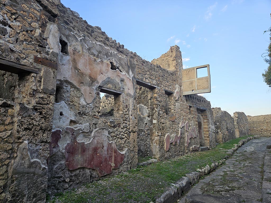 VII.15.4 and VII.15.5, Pompeii. November 2024. 
Looking east towards entrance doorways with VII.15.4 in centre, and VII.15.5, centre right. Photo courtesy of Annette Haug.