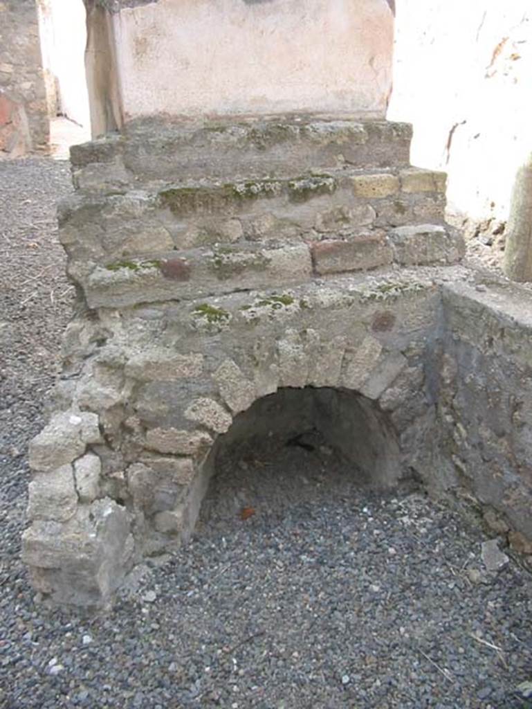 VII.15.5 Pompeii. May 2003. Looking north towards display shelving at end of counter, with recess below. 
Photo courtesy of Nicolas Monteix.