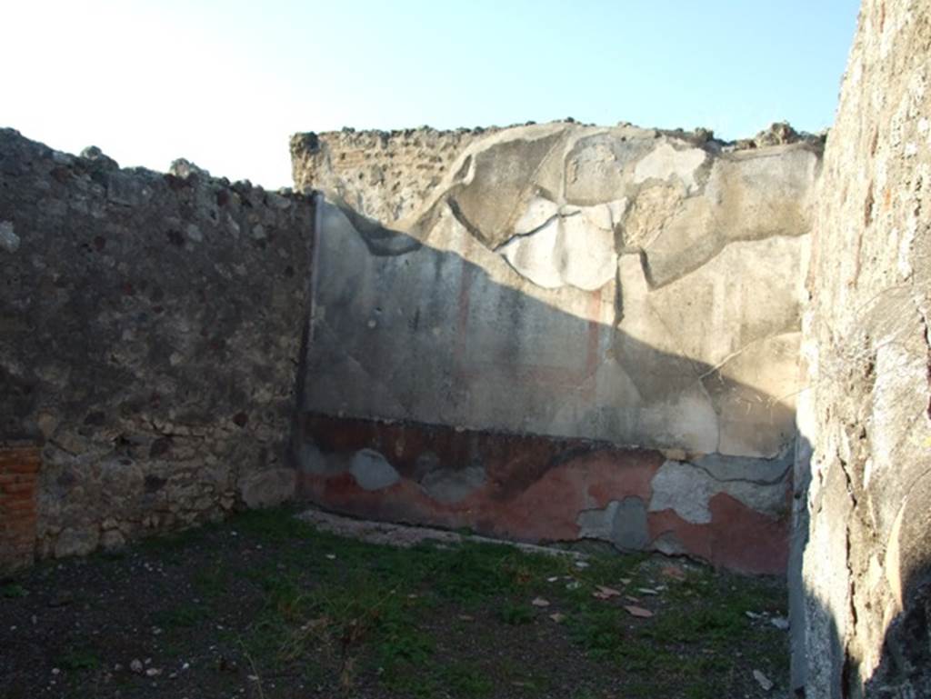 VII.15.13 Pompeii. December 2007. Looking north across triclinium in north-west corner of atrium.
The central painting of the sacred landscape with statue of Artemis has now faded, and disappeared.
The III Style decoration on the north wall showed at the centre an aedicola enclosed by white columns with a large red border.
The side panels were black.
See Sogliano, A: Le Pitture Murali Campane scoverte negli anni 1867-79.(p. 141, no.687).