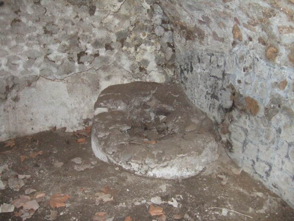 VII.15.16 Pompeii. May 2006. Open space (I), south-east corner with circular masonry base.   
According to Franklin, in the centre of the masonry base was a small basin.   
See Franklin, J.L. (Jnr) 1990. Pompeii, the Casa del Marinaio and its history. SAP, monograph 3. Roma; L’ERMA di Bretschnieder, (p.36).