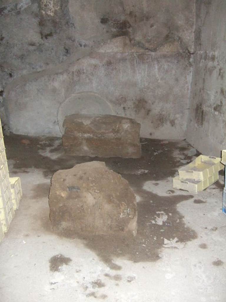 VII.15.16 Pompeii. May 2006. Room O, kneading room on south side of oven, looking east.
In the centre of the room are two masonry supports for a large work-table.
The walls would have had a high (1.60cm) red zoccolo and the wall above would have been painted white.
