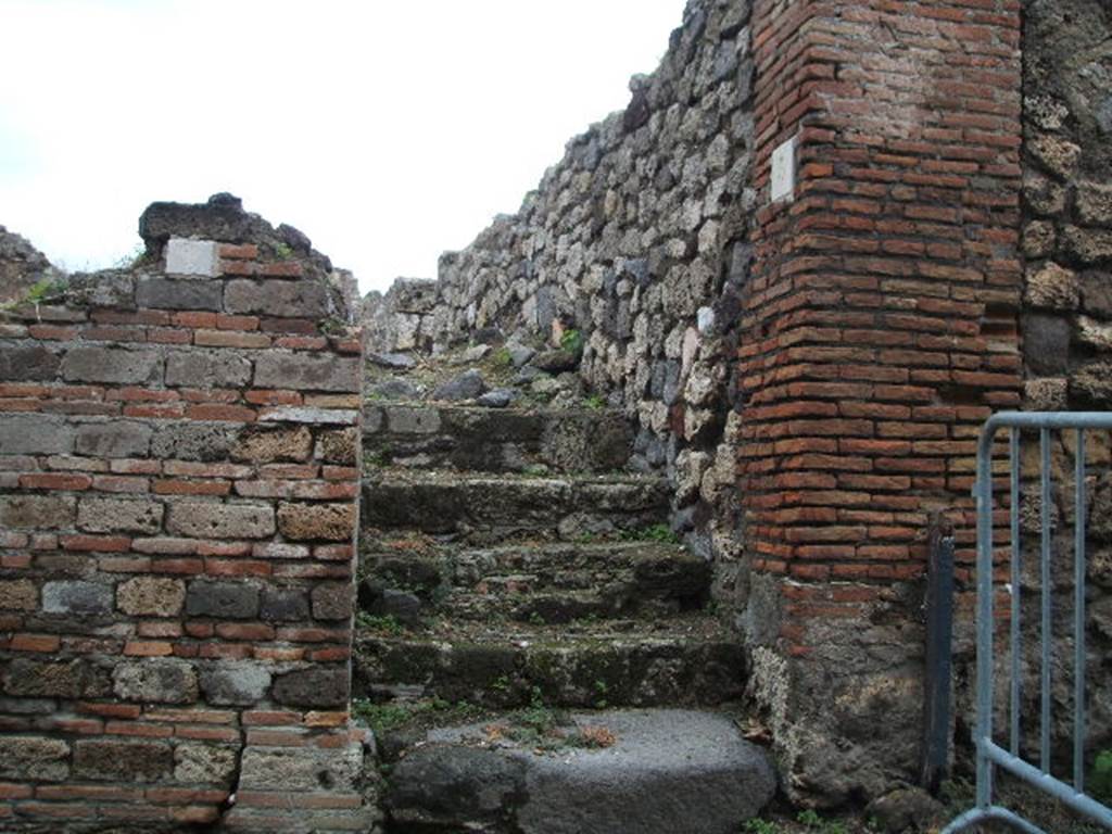 VII.16.5 Pompeii. December 2004. Steps to upper floor, looking north.
Originally, under these stairs would have been a small storeroom or cupboard with a doorway in the west wall of VII.16.6.
See Eschebach, L., 1993. Gebäudeverzeichnis und Stadtplan der antiken Stadt Pompeji. Köln: Böhlau. (p.347)