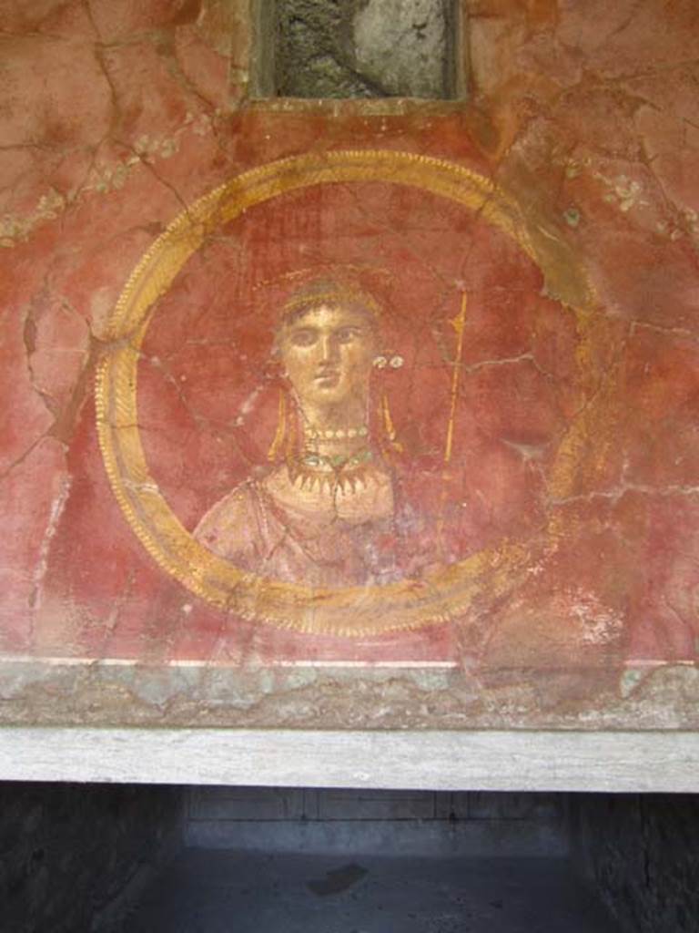 VII.16.17-22 Pompeii. May 2012.  Detail of painted face of female divinity in a round panel.
Photo courtesy of Marina Fuxa.