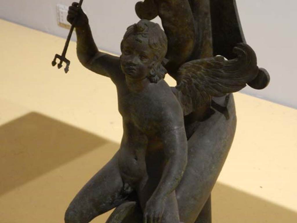 VII.16.17-22, Pompeii. May 2018. Bronze and marble table.
Detail of bronze cupid riding a dolphin, Archaeological Park of Pompeii, inv. 13371.  
Photo courtesy of Buzz Ferebee.
