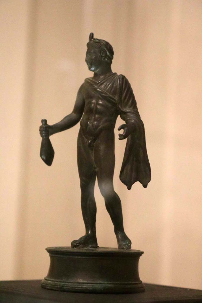 VII.16.17-22, Pompeii. December 2018. Bronze statuette of Mercury holding a sack of coins. 
Parco Archeologico di Pompei, inventory number 13987. Photo courtesy of Aude Durand.