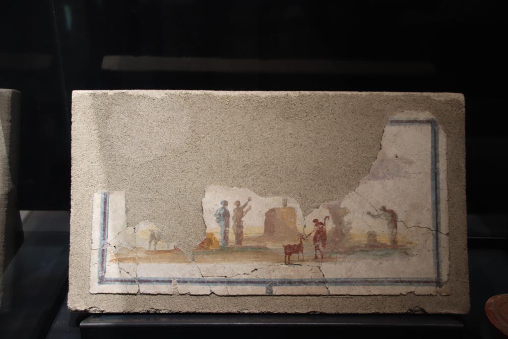 VII.16.a Pompeii. May 2024. 
Painting of idyllic sacred landscape on display in exhibition in palaestra, entitled “L’altra Pompei, vite comuni all’ombra del Vesuvio”. 
Photo courtesy of Klaus Heese.