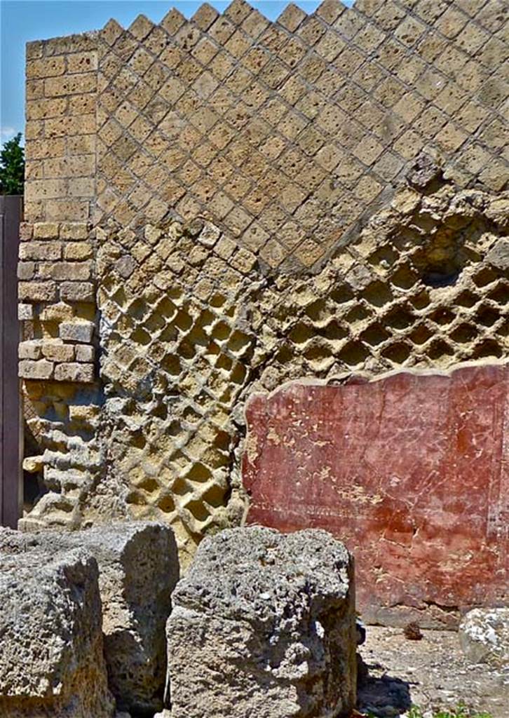 VII.16.a Pompeii. May 2011. Remains of painted wall stucco on east side of doorway to rooms on upper level of Suburban Baths, looking north. Photo courtesy of Michael Binns.