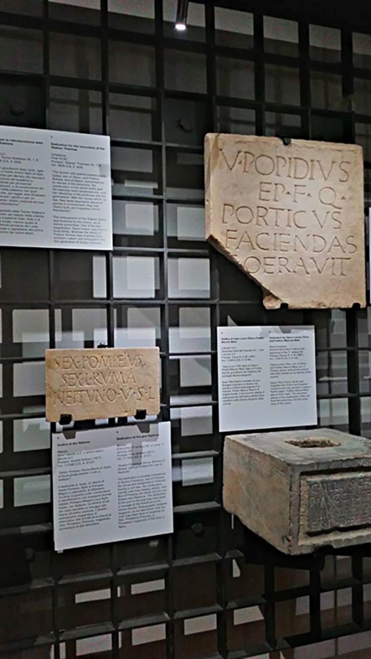VIII.1.1 Pompeii. Top right, found in front of the Basilica, 1814, 
“V. POPIDIUS, SON OF EPIDIUS, QUAESTOR, HAD THIS PORTICO BUILT”.
Now in Naples Archaeological Museum, inv. 3825 (CIL X, 794). Photo courtesy of Giuseppe Ciaramella, June 2017.
According to Naples Archaeological Museum information card –
“Marble dedication of a portico by the quaestor Vibius Popidius, from Early 1st century BC.
This is the earliest known Latin text from Pompeii. It refers to the tuff portico along the south side of the Forum.
The office of quaestor was not included in the statute of the colony founded by Sulla in 80 BC, but may have been in the statute introduced after the Social War (87 BC), and this possibly explains its occurrence here. The Popidii were one of the oldest local families and as such were excluded from the ruling class of the colony.”
Bottom left, from Temple of Neptune by the river mouth, loc Bottaro.
Bottom right, from VI.5.16.