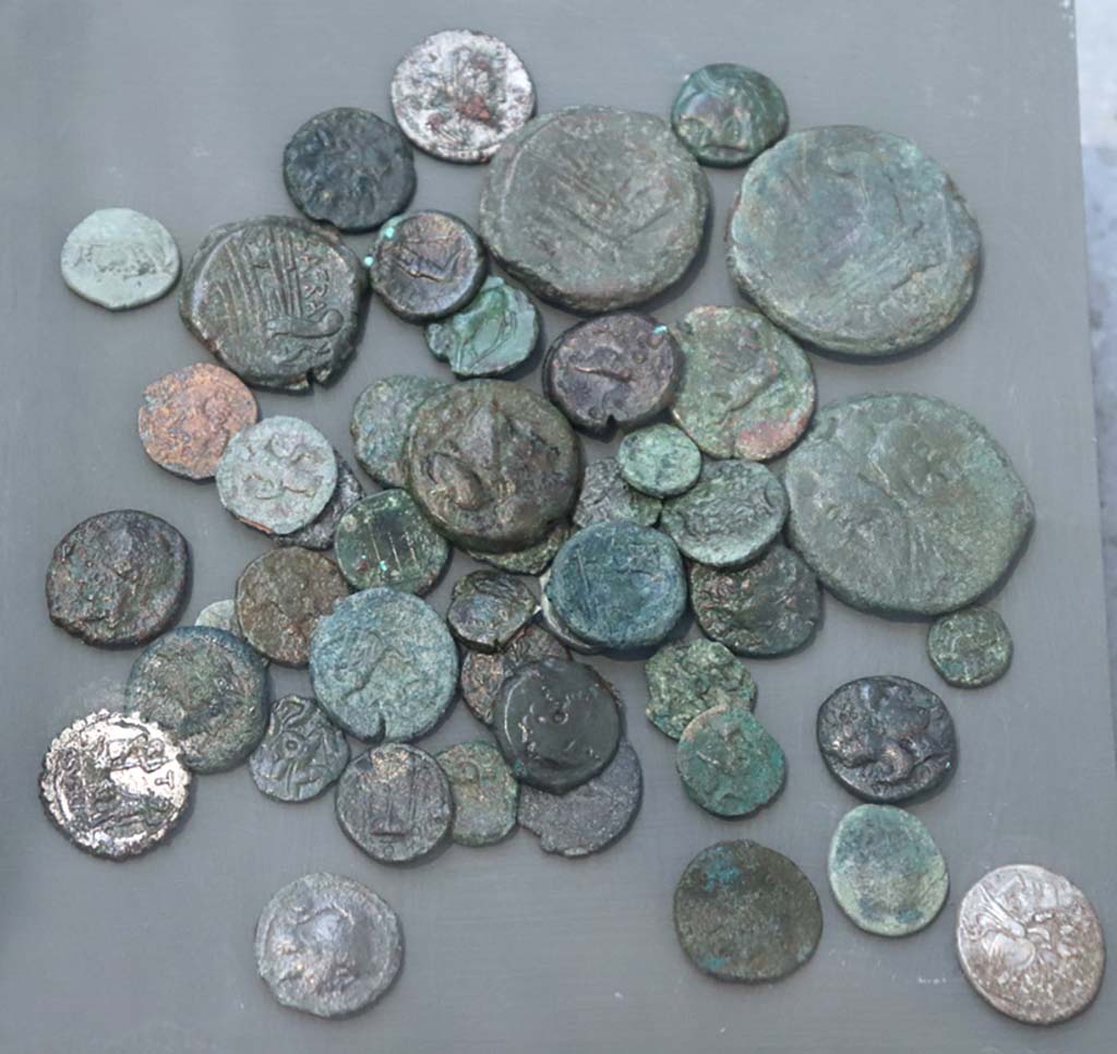 VIII.1.4 Pompeii. February 2021. Bronze coins in use in the 2nd century BCE, found in Pompeii.
Photo courtesy of Fabien Bièvre-Perrin (CC BY-NC-SA).