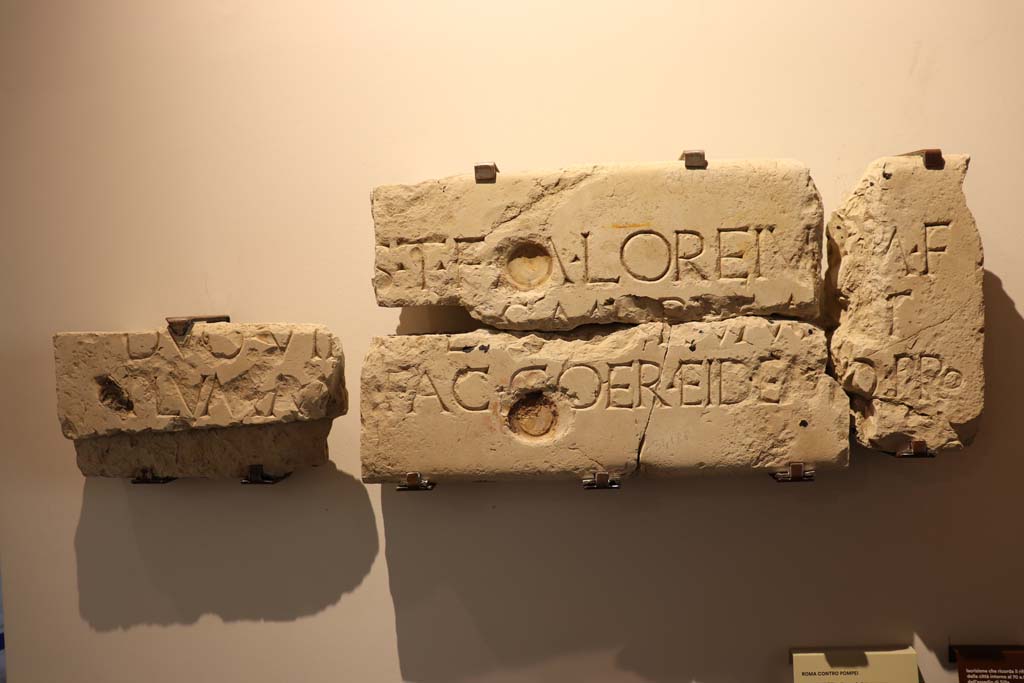 VIII.1.4 Pompeii. February 2021. 
Limestone inscription recording the rebuilding of the town walls in about 70BCE after the damages caused by Sulla’s siege, found in VII.1.40.
Photo courtesy of Fabien Bièvre-Perrin (CC BY-NC-SA).
According to Epigraphic Database Roma this and reads
It was found in VII.1.40, House of M. Caesius Blandus (or of Mars and Venus), in pieces 'some of which served for the edge of a door, and others spread on the floor of the peristyle' (aa. 1862-1868).