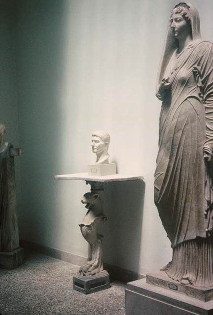 VIII.1.4, Antiquarium, Pompeii. August 1965. Sala di Livia or Room of Livia. 
Marble herm of Cornelius Rufus, the bust of a Poppeo, a monopodium table and statue of Livia. 
Photo courtesy of Rick Bauer.