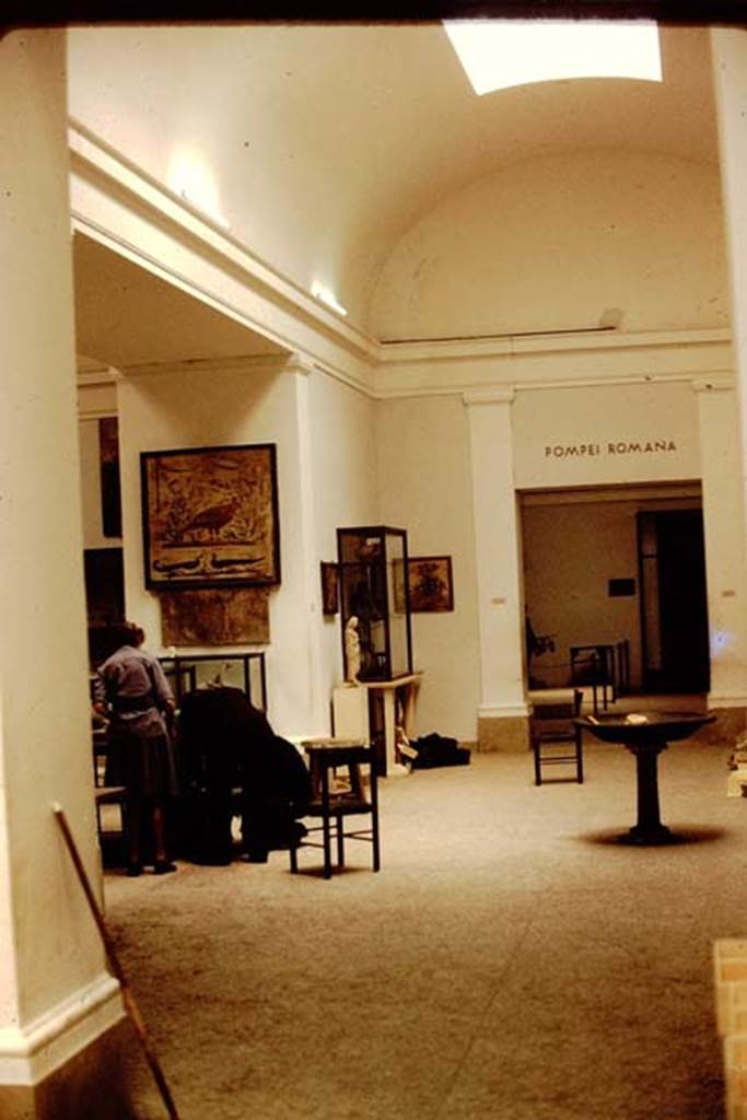 VIII.1.4 Pompeii Antiquarium. 1978. Working in room III with frescoes, marble statue and bronze basin on a pillar.
Photo by Stanley A. Jashemski.   
Source: The Wilhelmina and Stanley A. Jashemski archive in the University of Maryland Library, Special Collections (See collection page) and made available under the Creative Commons Attribution-Non-Commercial License v.4. See Licence and use details.
J78f0160