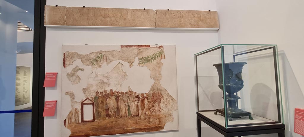 VIII.1.4 Pompeii. April 2022. 
Painting on wall from IX.7.1 showing procession in honour of the goddess Cybele. Photo courtesy of Giuseppe Ciaramella.
Her cult statue is seated on a wooden litter beside which stand four bearers with garlands in their hair. 
Behind her are two rows of worshippers led by a priest and priestess.
Some of the worshippers are playing the Pan Pipes or double flute, others beating tambourines or clashing cymbals. 
See Fröhlich, T., 1991, Lararien und Fassadenbilder in den Vesuvstädten. Mainz: von Zabern. (F63: p.332, T. 59,2).