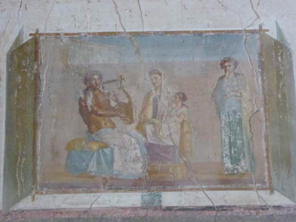VIII.1.a, Pompeii. June 2017. Painted panel from west end of south wall of enthroned Pindar with lyre, with Muse and poetess?
Photo courtesy of Michael Binns.