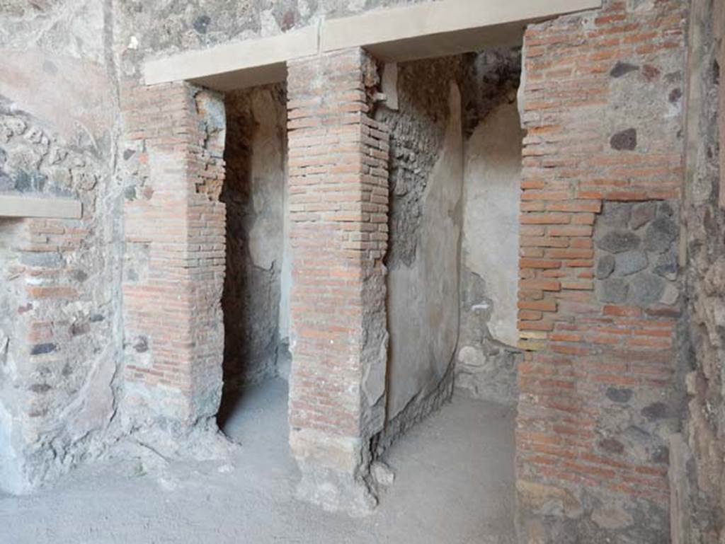 VIII.2.1 Pompeii. May 2018. Looking east in ala towards two doorways to cupboards in south-east corner of atrium.
On the left is the small doorway from the east oecus. Photo courtesy of Buzz Ferebee.