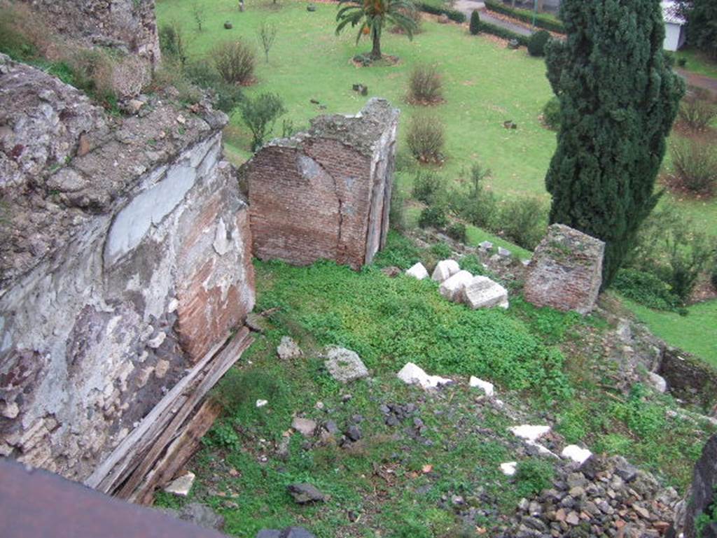 VIII.2.1 Pompeii. December 2005. 
Looking from south portico to lower floors which would have been under the terrace.  
According to PPM –
This photo is looking down onto the large triclinium (called “J”) which would have had a panoramic view to the south, the east wall is on the left.
According to PPM –
This would have had walls painted in the IV Style with a decorative scheme with partitions, not reconstructable as the plaster had fallen: 
the white background was also taken up into the vault, where some traces of squares with large rectangles remain.
See Carratelli, G. P., 1990-2003. Pompei: Pitture e Mosaici. VIII (8) Roma: Istituto della enciclopedia italiana, (p.55, no.53).
Looking ahead to area of cubiculum (θ) and triclinium (η).
According to PPM –
The work of liberation of the southern slopes of the city from the product of the eruption, following immediately after the war, had brought to light other rooms probably pertinent to this house.
In room (η), the north wall had a large window (?) looking into cubiculum (θ), and was decorated in II Style.
On the west side of this room “J” (on the right), would have been another large room, (called (К)  similar to large triclinium “J”), linked by a doorway.