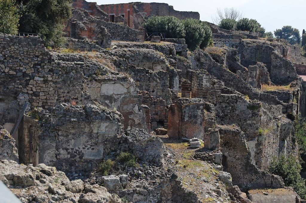 VIII.2.1 Pompeii. April 2011. Looking across east from area of large room (К),   with vaulted ceiling on lower left, into area of large triclinium “J”.
In the centre of the photo, behind triclinium “J”, the remains of the vaulted ceiling of the large triclinium in VIII.2.3/VIII.2.16 can be seen.
In the upper right of the photo are the rooms belonging to the rear rooms of VIII.2.14-16.
Photo courtesy of Sandra Zanella.