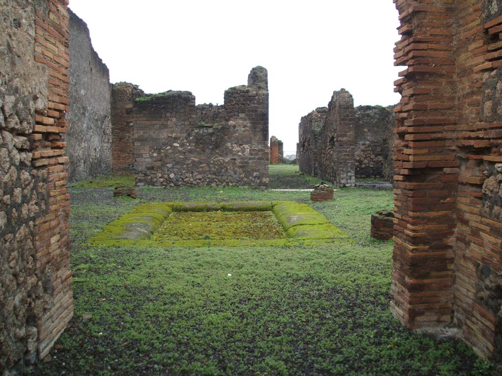 VIII.2.14 Pompeii. December 2004. Looking across atrium towards rooms at rear, from entrance corridor.
According to Jashemski, at the rear was a large peristyle garden, linked to VIII.2.16 by a room, opening on both ends to a different peristyle.
This garden was laid out on a volcanic ledge and was enclosed on four sides by a portico supported by fourteen columns.
There was a rectangular pool in the south-east corner of the peristyle, which had amphorae in it.
These would have served as a shady retreat for fish.
See Jashemski, W. F., 1993. The Gardens of Pompeii, Volume II: Appendices. New York: Caratzas. (p.205)