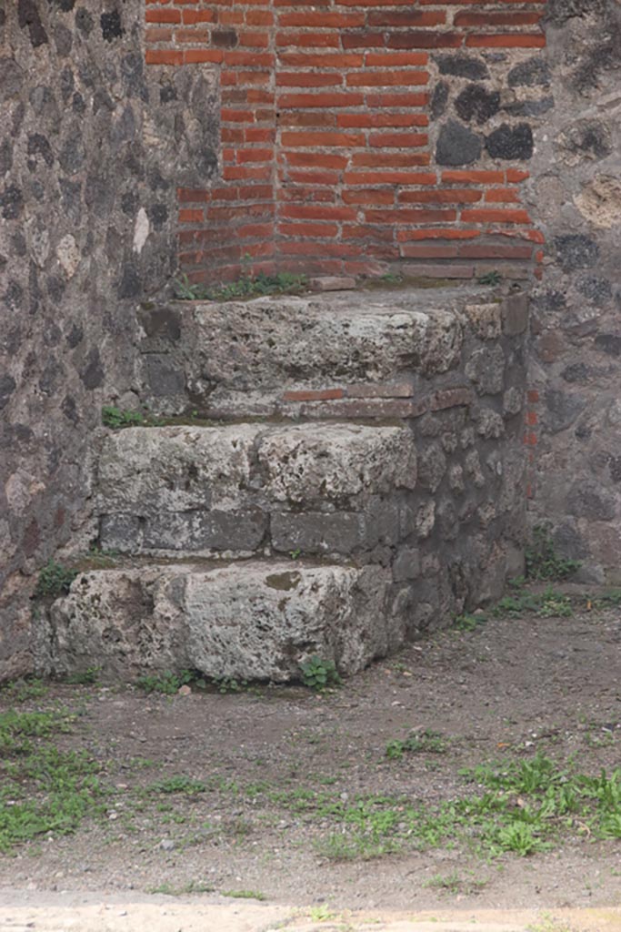 VIII.2.15 Pompeii. October 2023. 
Stone steps in south-west corner of shop. Photo courtesy of Klaus Heese.