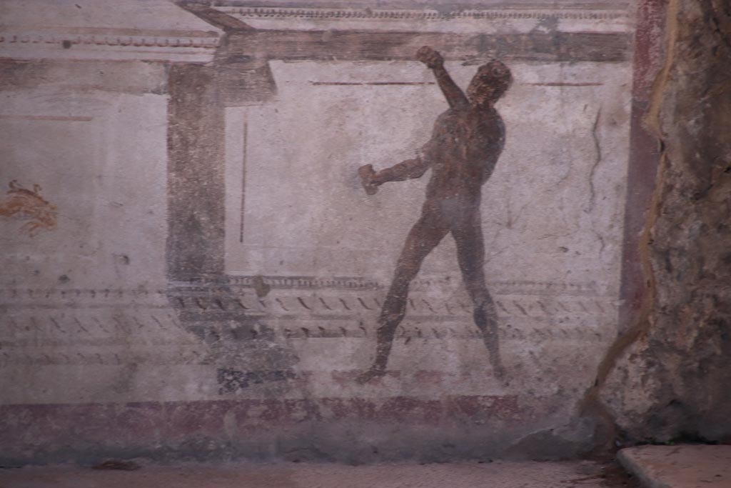VIII.2.23 Pompeii. October 2022. 
Detail of painted figure on the zoccolo/dado at the west end of the south wall. Photo courtesy of Klaus Heese.