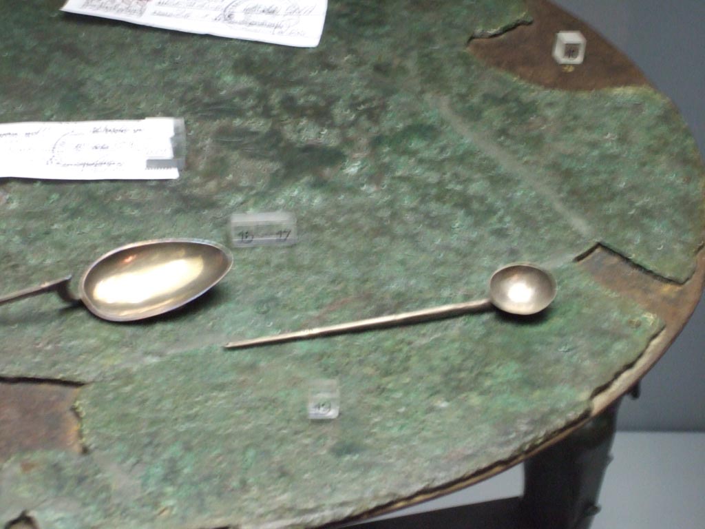 Silver spoon, of type cochlear, with round bowl, found 20th September 1887 in VIII.2.23.  
Now in Naples Archaeological Museum.