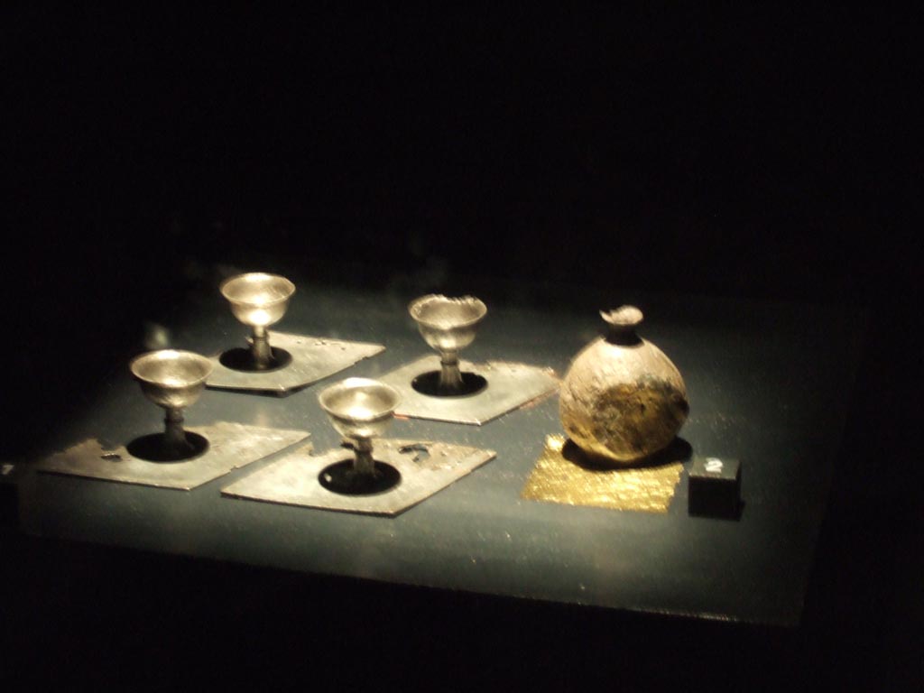 Silver found 20th September 1887 in VIII.2.23. Now in Naples Archaeological Museum.
Four egg cups (left). Inventory numbers 116349, 116350, 116351 and 116352.
Round pepper pot in the form of a small vase (right). Inventory number 116354.
See Guzzo, P. (A cura di), 2006. Argenti a Pompei. Milano, Electa. (p. 134).