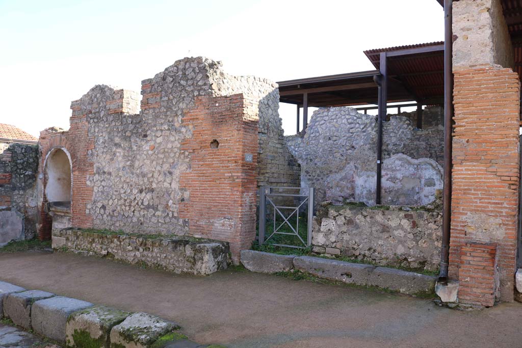 VIII.2.24, Pompeii, on right, with altar at VIII.2.25, on left. December 2018. 
Looking towards entrances on south side of Via della Regina. Photo courtesy of Aude Durand.