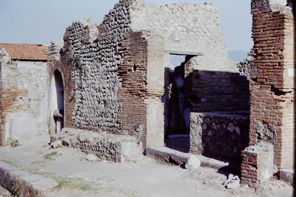 VIII.2.24 Pompeii. 1968. Looking east to entrance doorway, and bench outside near street shrine, on left.  Photo by Stanley A. Jashemski.
Source: The Wilhelmina and Stanley A. Jashemski archive in the University of Maryland Library, Special Collections (See collection page) and made available under the Creative Commons Attribution-Non Commercial License v.4. See Licence and use details.
J68f2334