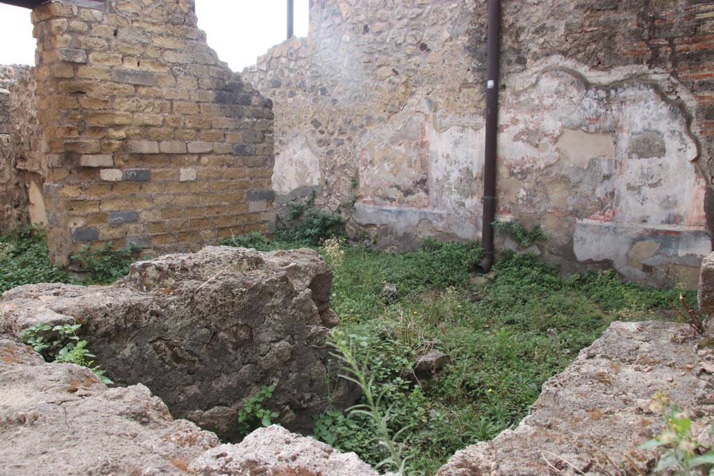 VIII.2.24 Pompeii. October 2023. 
Looking south-east across bar-room, with doorway into the kitchen with hearth and latrine, on left. Photo courtesy of Klaus Heese.