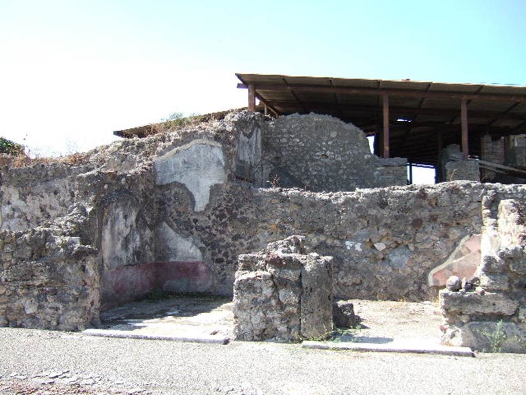 VIII.2.26 Pompeii. September 2005. Doorways to two cubicula on west side of atrium. Room ‘o’ on the left, and room ‘p’ on the right.
 In room ‘o’, the floor was found paved with simple white mosaic with a border of black tesserae. On the south wall (on left), the purple zoccolo showed a motive of a taut garland with a disc at the centre, and a border of ‘carpet’ squares. The middle zone was subdivided into panels, of which the central panel was on a blue background, and showed a painting already unrecognisable at the time of excavation. The side panel was black. On the west wall, the upper zone of the wall although discoloured and faded, showed traces of architectural partitions but not very well defined.
In room ‘p’, the floor was of cocciopesto similar to that seen in the room ‘L’. In the north corner of the west wall, the remains of the plaster of the red zoccolo and the darker red of the middle zone can still be seen. Nothing remains from the other walls and no evidence from the south wall where Mau could see a painting, partly preserved, of Venere Pescatrice. She was seen turning towards the left.