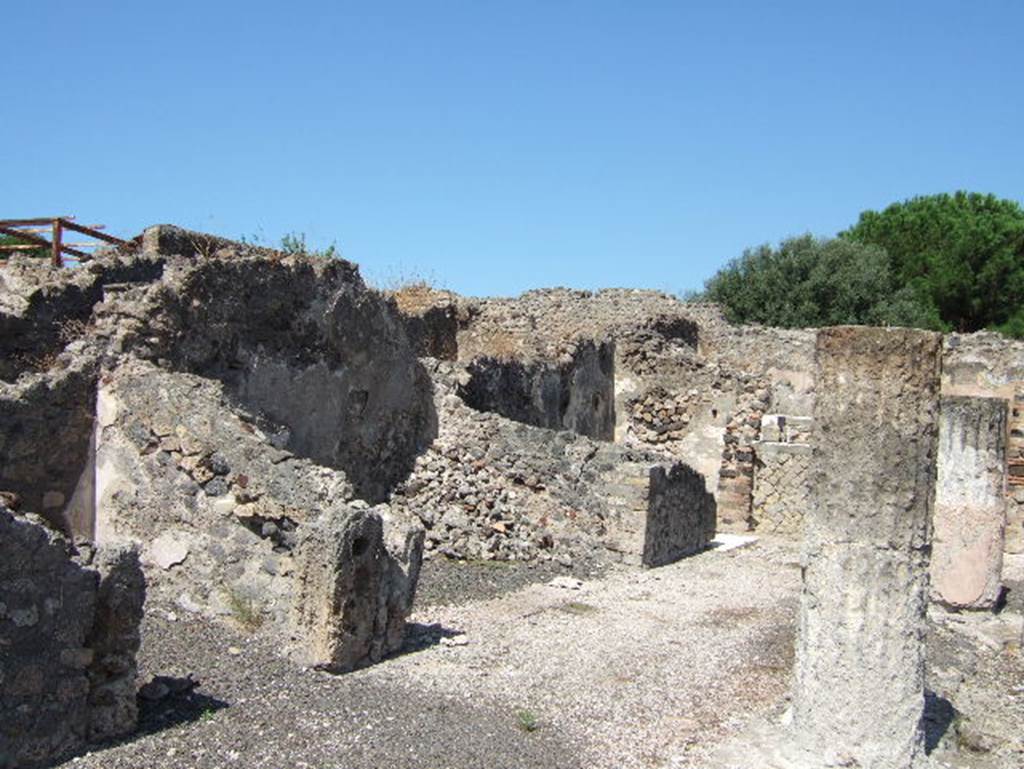 VIII.2.28 Pompeii. September 2005. Rooms on west side of atrium. According to Richardson, the rooms on the west side of the atrium were much shallower than those on the east.
The small rooms on either side of the central ala may have been storerooms.
See Richardson, L., 1988. Pompeii: an Architectural History. Baltimore: John Hopkins University Press. (p.231-2).
In the north-west corner of the atrium is a masonry base, just visible to the left of the column. This was the lararium. The top of it had three small steps of marble (see below). 
The aedicula that was originally on the base has disappeared. On the north wall above the base, when excavated, the figures of the Lares could still be seen.
See Boyce G. K., 1937. Corpus of the Lararia of Pompeii. Rome: MAAR 14. (p74, no.345)