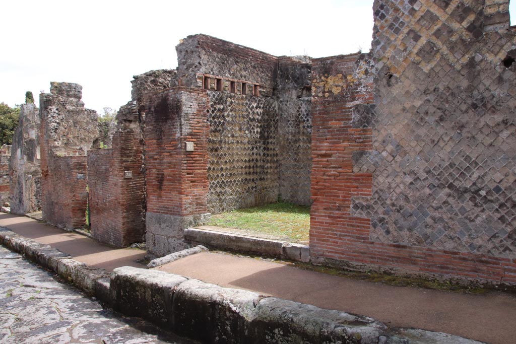 VIII.2.31 Pompeii. May 2024.  
Looking east along south side of Via della Regina towards entrance doorway. Photo courtesy of Klaus Heese.