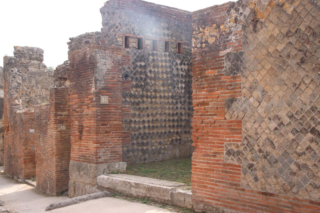 VIII.2.31 Pompeii. October 2023. 
Looking east along south side of Via della Regina towards entrance doorways. Photo courtesy of Klaus Heese.