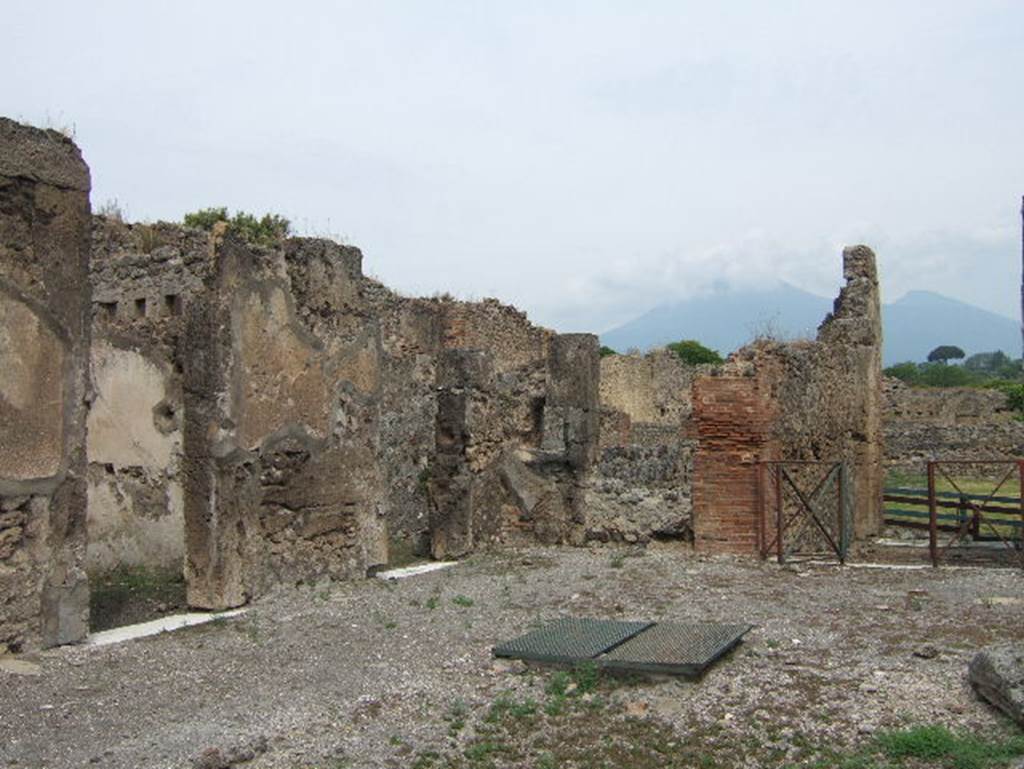 VIII.2.34 Pompeii. May 2006.  North-west corner of atrium ‘c’ with doorway to small room ‘L’ and doorway linking to room ‘q’, kitchen area and VIII.2.33.