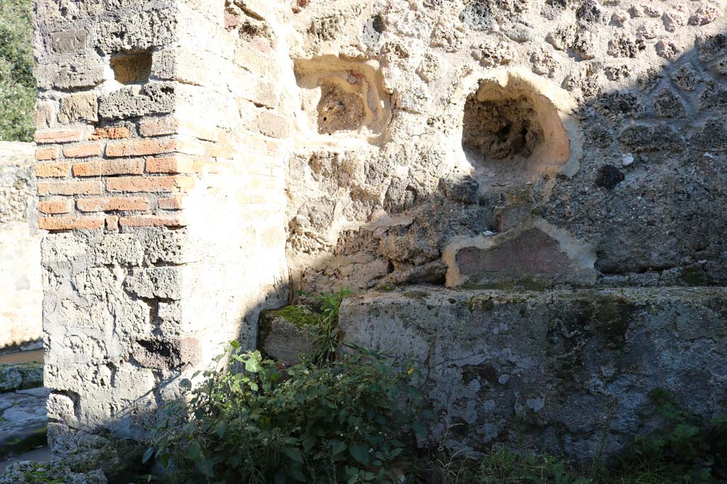 VIII.2.35 Pompeii. December 2018. 
Looking towards east wall in north-east corner near entrance doorway. Photo courtesy of Aude Durand.
According to Boyce –
in the east wall of this taberna with thermopolium, is an arched niche (h.0.30, w.0.38, d.0.28, h. above floor 1.05).
Its walls were coated with red stucco.
See Boyce G. K., 1937. Corpus of the Lararia of Pompeii. Rome: MAAR 14. (p.75, no.348)