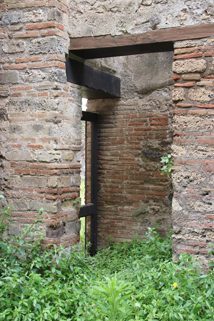 VIII.2.38 Pompeii. May 2024. 
South-east corner of shop-room with doorway to kitchen of VIII.2.39. Photo courtesy of Klaus Heese.